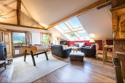 a living room with a pool table in the middle at Accommodation of 167 m2 with views of Mont Blanc in Combloux