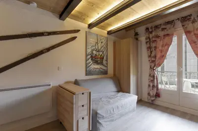 a small bedroom with a bed and a window at Blanc Neige in Chamonix-Mont-Blanc