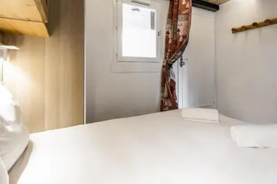 a bedroom with a white bed and a window at Blanc Neige in Chamonix-Mont-Blanc
