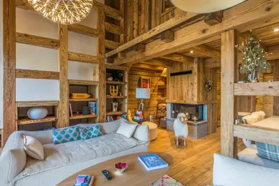 a living room with a couch and a fireplace at Appartement Jaillet - Welkeys in Megève