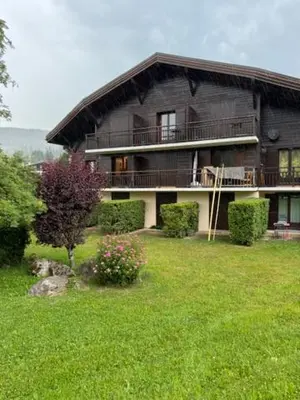 a large house in a field of green grass at Le chalet des pistes in Demi-Quartier