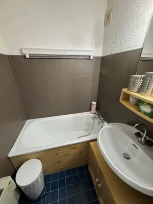 a bathroom with a tub and a toilet and a sink at Le chalet des pistes in Demi-Quartier