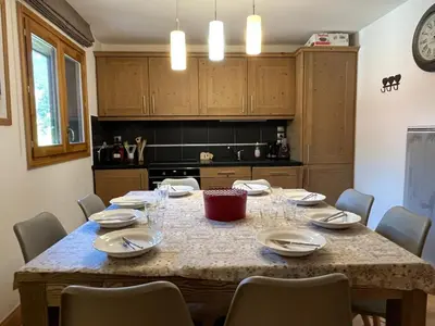 a kitchen with a table with chairs around it at T4 Duplex à Samoëns, standing avec balcon & parking privé - FR-1-629-149 in Samoëns