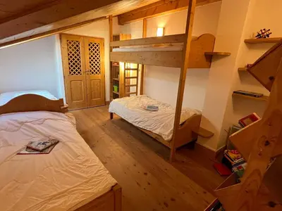 a room with two beds and a bunk bed at T4 Duplex à Samoëns, standing avec balcon & parking privé - FR-1-629-149 in Samoëns