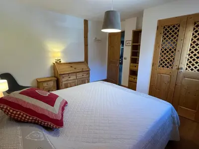 a bedroom with a bed with a red pillow on it at T4 Duplex à Samoëns, standing avec balcon & parking privé - FR-1-629-149 in Samoëns