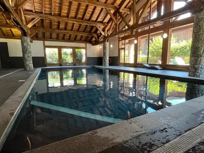 an indoor swimming pool in a house with a ceiling at T4 Duplex à Samoëns, standing avec balcon & parking privé - FR-1-629-149 in Samoëns