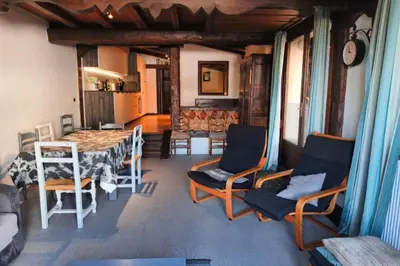 a living room with a table and chairs in a room at South-facing flat with garden near city center in Saint-Gervais-les-Bains
