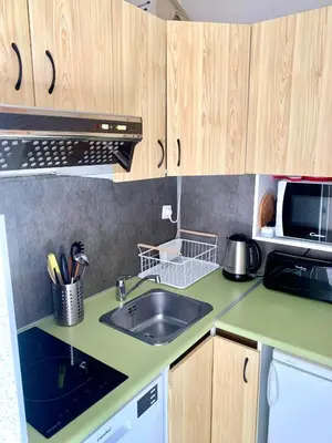 a kitchen with a sink and a microwave at Studio cosy au cœur de la station des Carroz in Arâches-la-Frasse