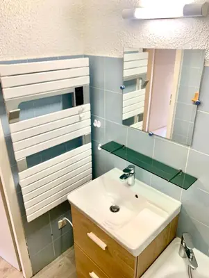 a bathroom with a sink and a mirror at Studio cosy au cœur de la station des Carroz in Arâches-la-Frasse