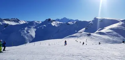 a group of people skiing down a snow covered mountain at Studio cosy au cœur de la station des Carroz in Arâches-la-Frasse
