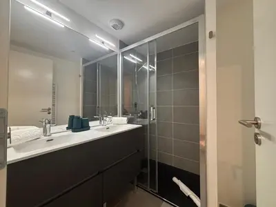 a bathroom with a sink and a large mirror at Kayla du Mont-Blanc - Espace bien etre - Piscine in Les Houches