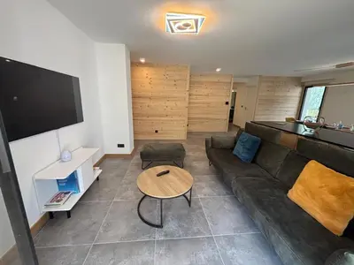 a living room with a couch and a table at Kayla du Mont-Blanc - Espace bien etre - Piscine in Les Houches
