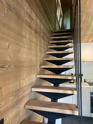 a staircase in a house with wooden walls at 35 m2 duplex in a new 2025 chalet in Saint-Gervais-les-Bains