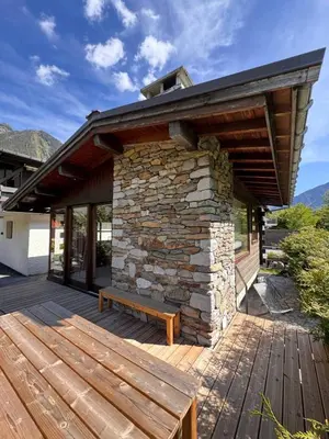 a wooden deck with a bench on a house at Chalet Meta by Brennus Chamonix in Chamonix-Mont-Blanc