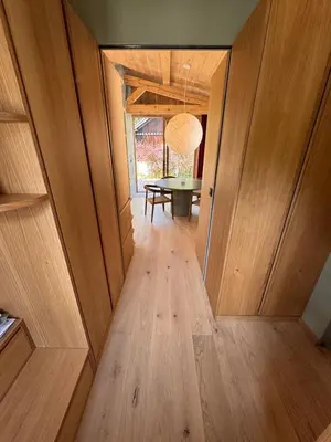 a hallway with a table in a room with wooden walls at Chalet Meta by Brennus Chamonix in Chamonix-Mont-Blanc