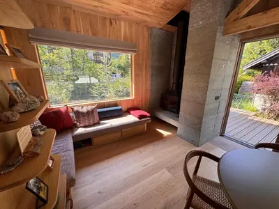 a living room with a large window and a couch at Chalet Meta by Brennus Chamonix in Chamonix-Mont-Blanc