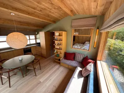 a tiny house with a table and a couch at Chalet Meta by Brennus Chamonix in Chamonix-Mont-Blanc