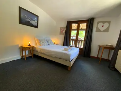a bedroom with a bed and a window at Hôtel-Bar-Restaurant Les Dômes de Miage in Saint-Gervais-les-Bains