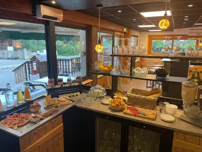 a kitchen with a counter with food on it at Hôtel-Bar-Restaurant Les Dômes de Miage in Saint-Gervais-les-Bains