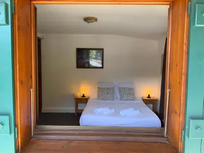 a bedroom with a white bed with two night stands at Hôtel-Bar-Restaurant Les Dômes de Miage in Saint-Gervais-les-Bains