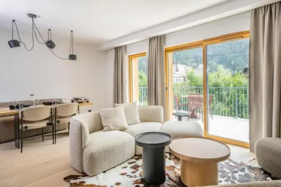 a living room with a couch and a table at Paradisa Cosmique Moderne 2-bedroom with amazing Mont-Blanc view! in Chamonix-Mont-Blanc