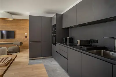 a kitchen with gray cabinets and a sink at Paradisa Cosmique Moderne 2-bedroom with amazing Mont-Blanc view! in Chamonix-Mont-Blanc