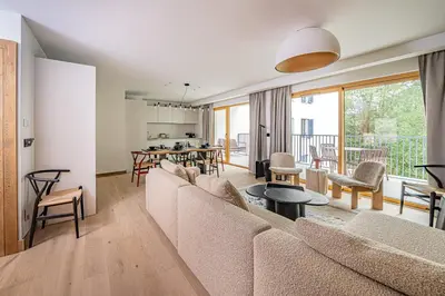 a living room with a couch and a table at Paradisa Balcon du Géant Elegantly designed 4-bedroom apartment in Chamonix-Mont-Blanc