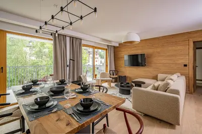 a living room with a table and a couch at Paradisa Balcon du Géant Elegantly designed 4-bedroom apartment in Chamonix-Mont-Blanc