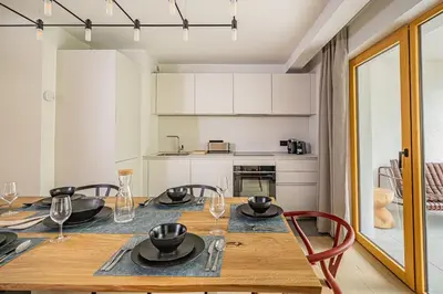 a kitchen and dining room with a table and chairs at Paradisa Balcon du Géant Elegantly designed 4-bedroom apartment in Chamonix-Mont-Blanc