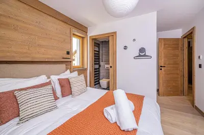 a bedroom with a large white bed with pillows at Paradisa Balcon du Géant Elegantly designed 4-bedroom apartment in Chamonix-Mont-Blanc