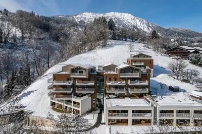 an apartment building on top of a snow covered hill at Apartment Alpinea, Les Houches - by EMERALD STAY in Les Houches