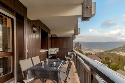 a balcony with a table and chairs and a view at La vue du Rosay - Balcon - Vues in Saint-Gervais-les-Bains