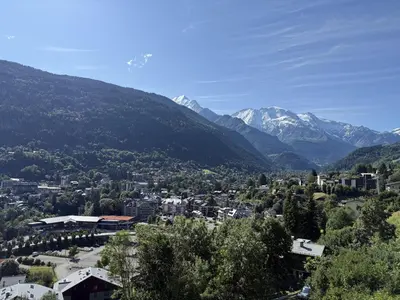 a view of a town with mountains in the background at La vue du Rosay - Balcon - Vues in Saint-Gervais-les-Bains