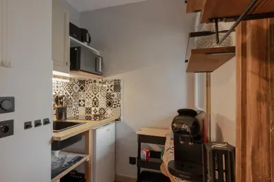 a small kitchen with a stove and a microwave at La vue du Rosay - Balcon - Vues in Saint-Gervais-les-Bains