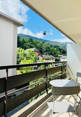a balcony with a table and a view at Balcons Alpins - Appartement rénové à St-Gervais in Saint-Gervais-les-Bains
