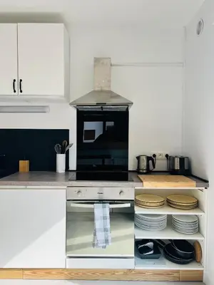 a kitchen with a counter top with a microwave at Balcons Alpins - Appartement rénové à St-Gervais in Saint-Gervais-les-Bains