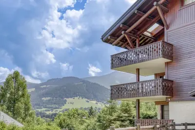 a house with balconies and a view of mountains at Paradiso in Megève