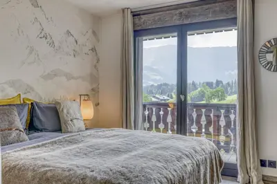 a bedroom with a bed and a large window at Paradiso in Megève