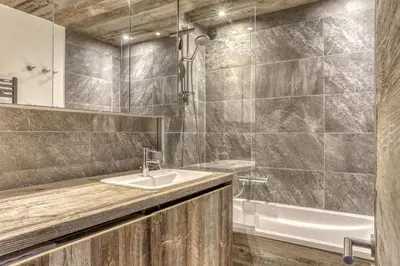 a bathroom with a sink and a tub at Paradiso in Megève