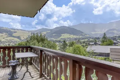 a balcony with a table and a view of mountains at Paradiso in Megève