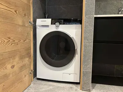 a white washing machine sitting in a kitchen at Le Yeti (4 Pers) in Chamonix-Mont-Blanc