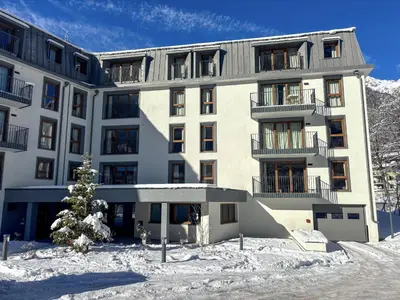 a building in the snow with a christmas tree in front at Le Yeti (4 Pers) in Chamonix-Mont-Blanc