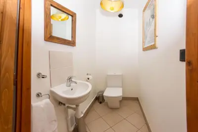 a bathroom with a sink and a toilet and a mirror at Le Paradis 24 apartment - Chamonix All Year in Chamonix-Mont-Blanc
