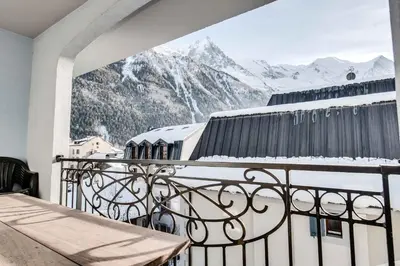 a balcony with a view of a snow covered mountain at Le Paradis 27 apartment - Chamonix All Year in Chamonix-Mont-Blanc