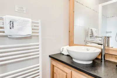 a bathroom with a white sink and a mirror at Le Paradis 27 apartment - Chamonix All Year in Chamonix-Mont-Blanc
