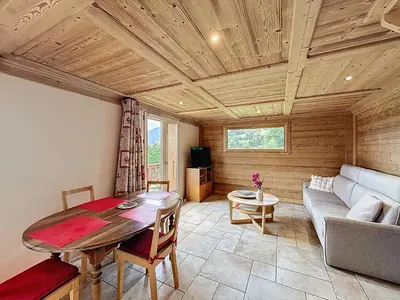 a living room with a table and a couch at Appartement 2 chambres, mezzanine, vue Mont Blanc, proche village, parking - FR-1-560-164 in Combloux