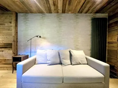 a white couch in a room with a lamp at Cozy apartment in Mègeve center in Megève