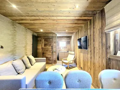 a living room with a white couch and blue chairs at Cozy apartment in Mègeve center in Megève