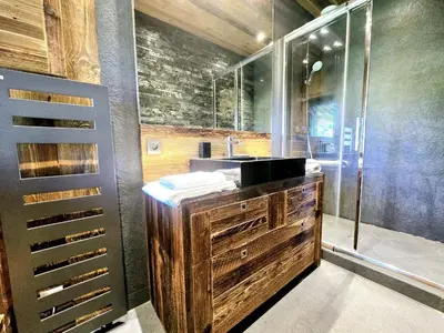 a bathroom with a wooden sink and a shower at Cozy apartment in Mègeve center in Megève