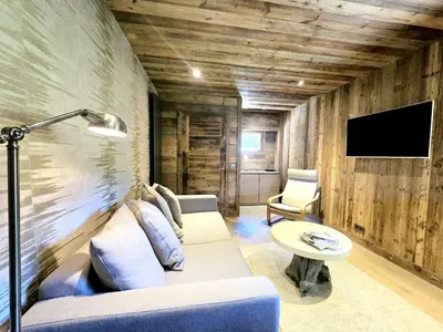 a living room with a couch and a table at Cozy apartment in Mègeve center in Megève